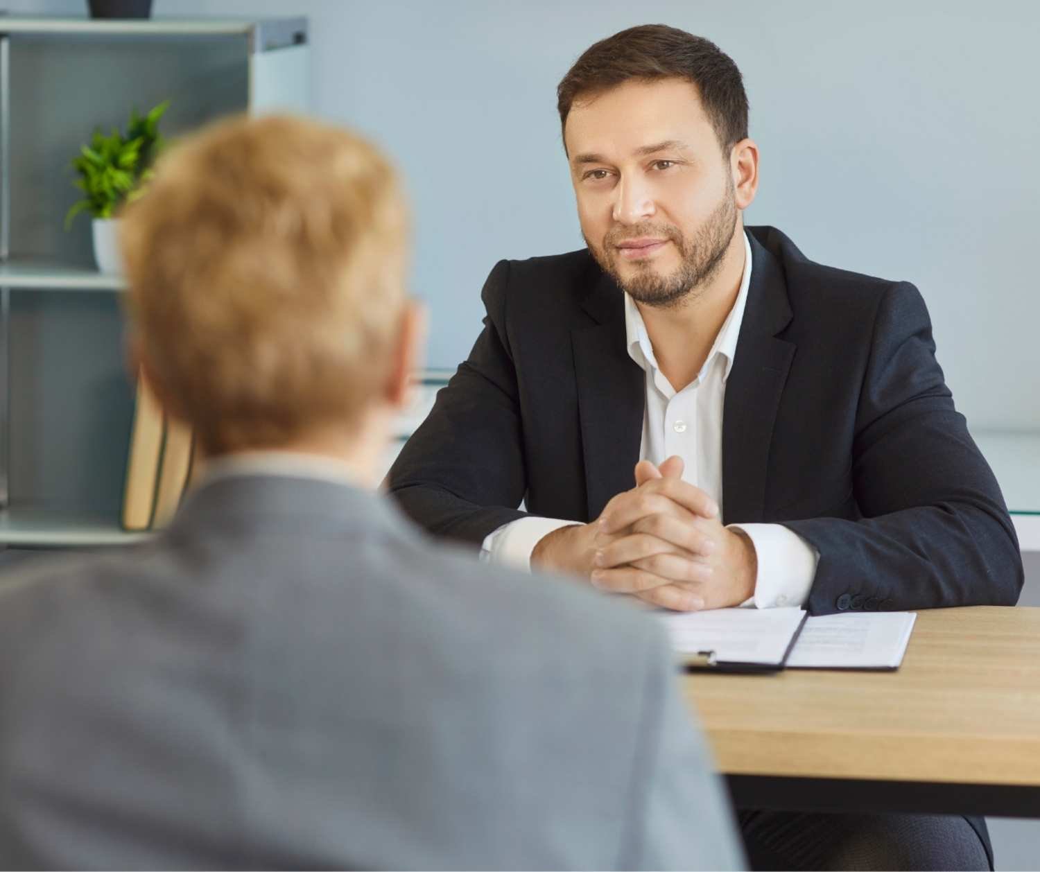 HR professional meeting privately with an employee in an office