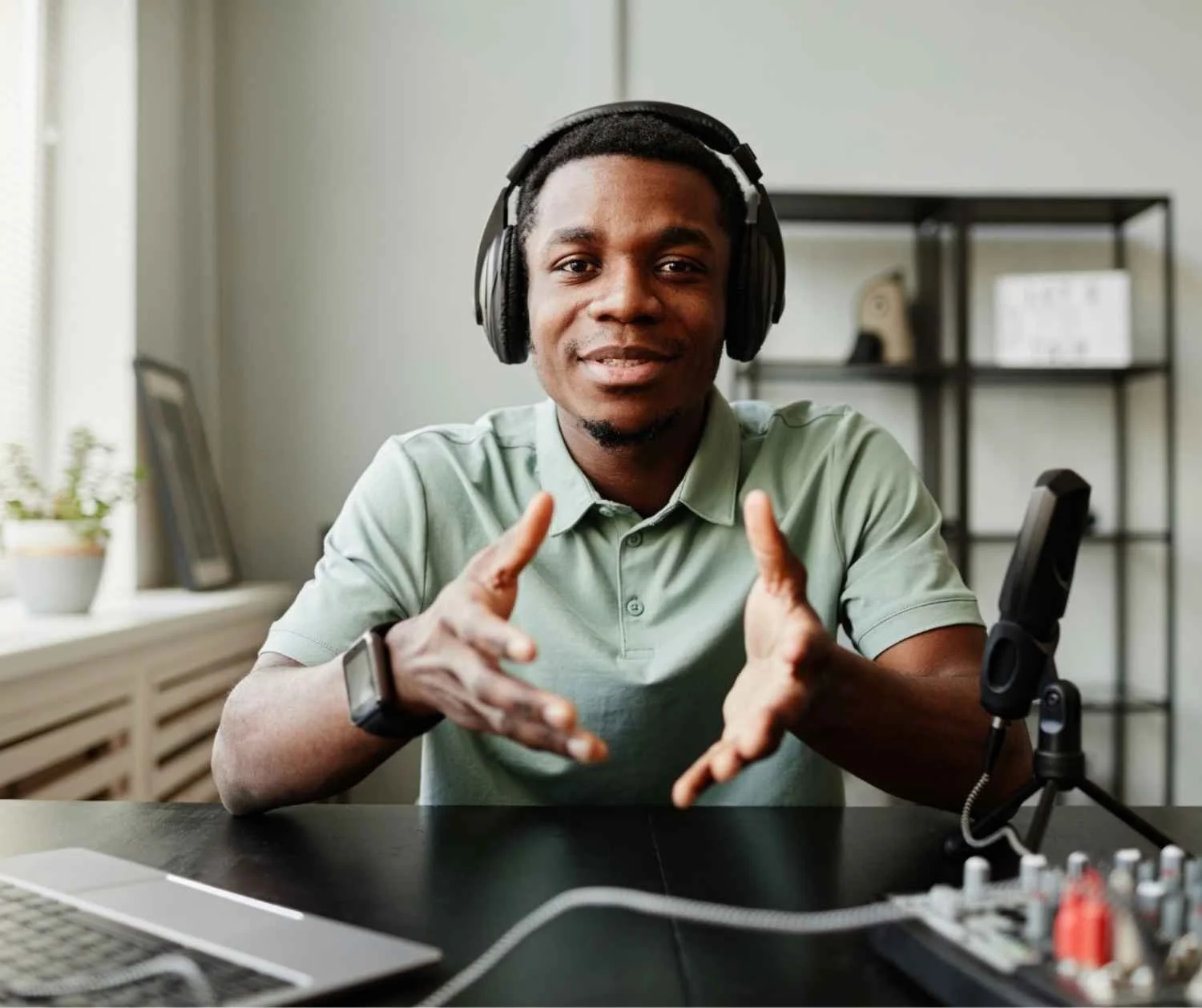 Man speaking to camera at worktable