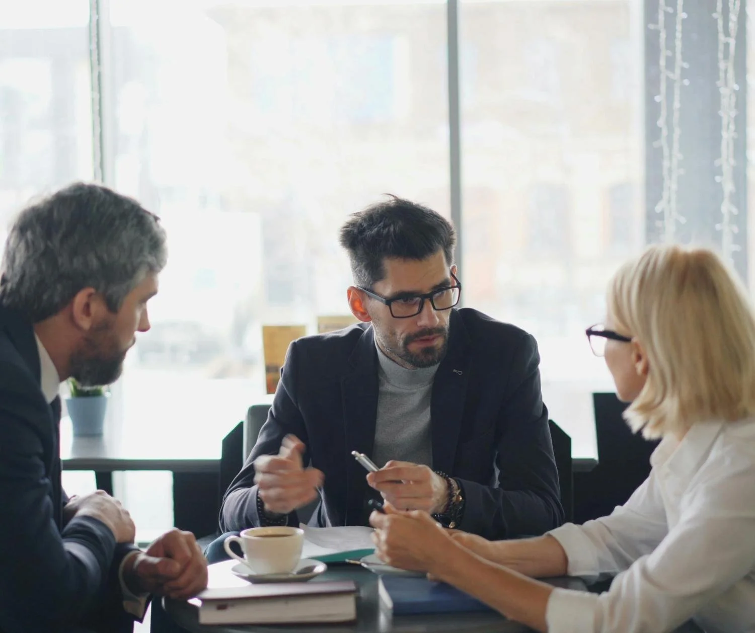Three colleagues talking in a meeting