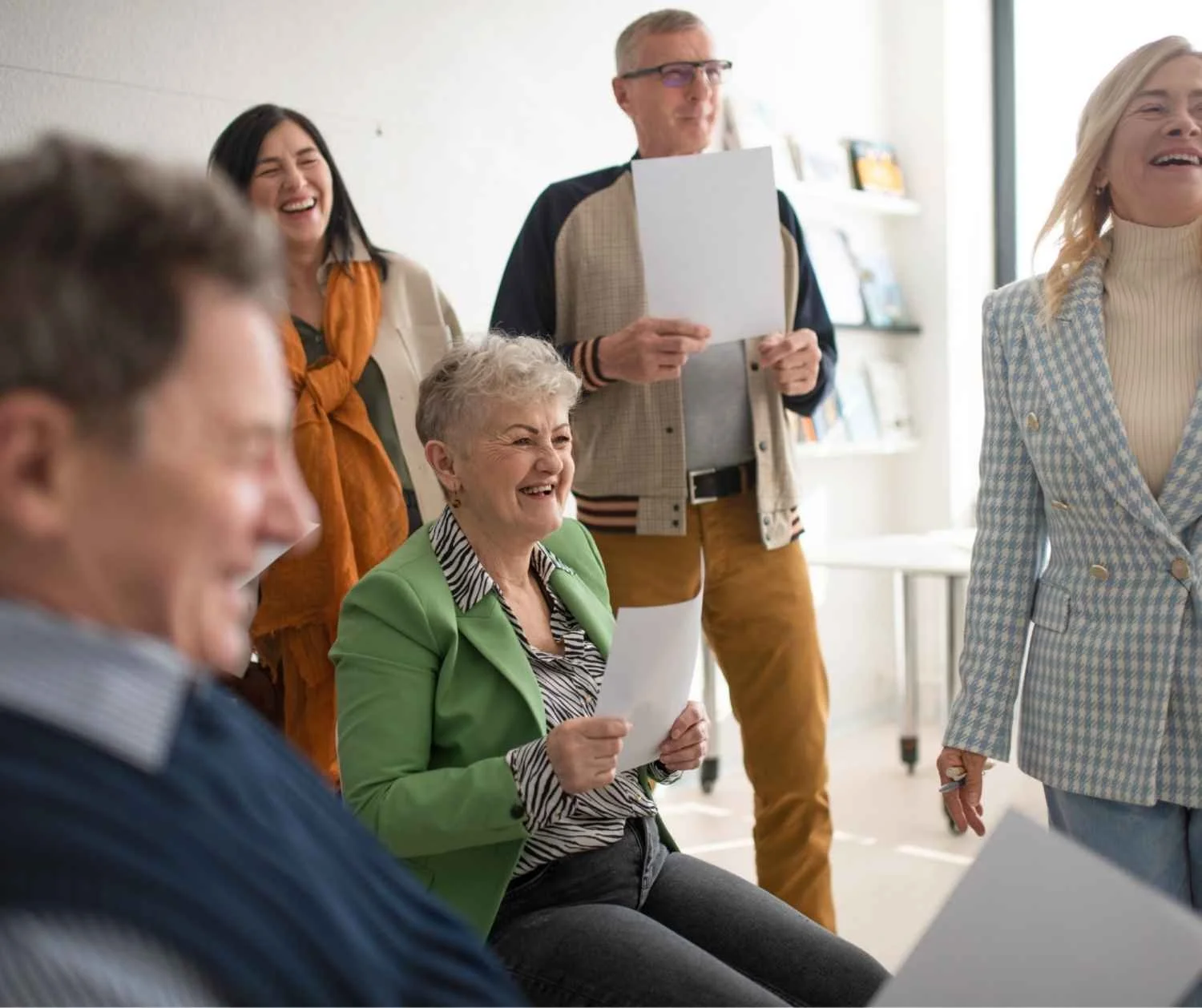 Adults singing together at a community choir rehearsal