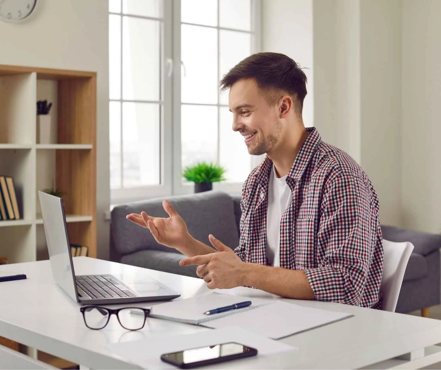 Man talking with his coach on a video call from his home office