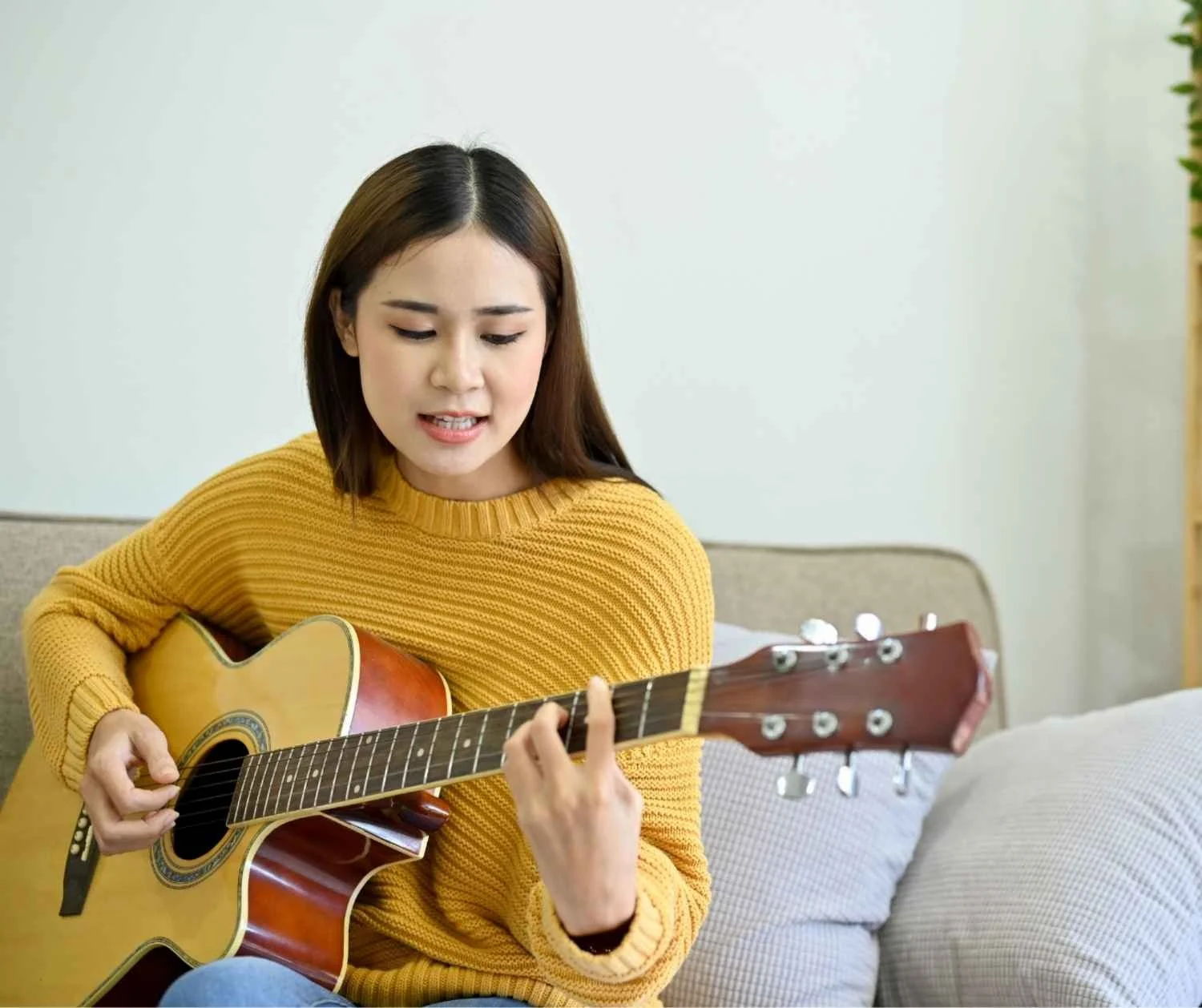 Woman singing softly in her living room.
