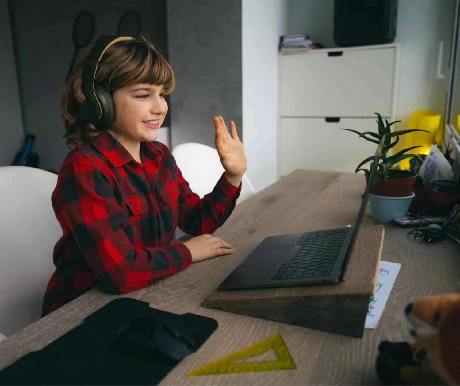 Boy at home on a video call with his speech-language pathologist