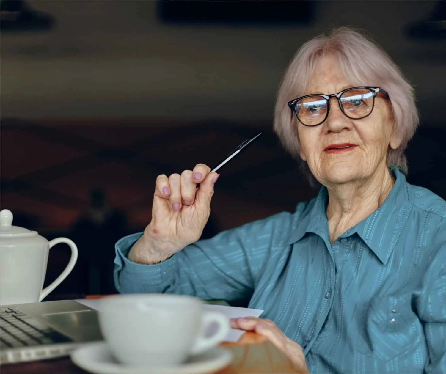 older woman straining to hear in busy cafe