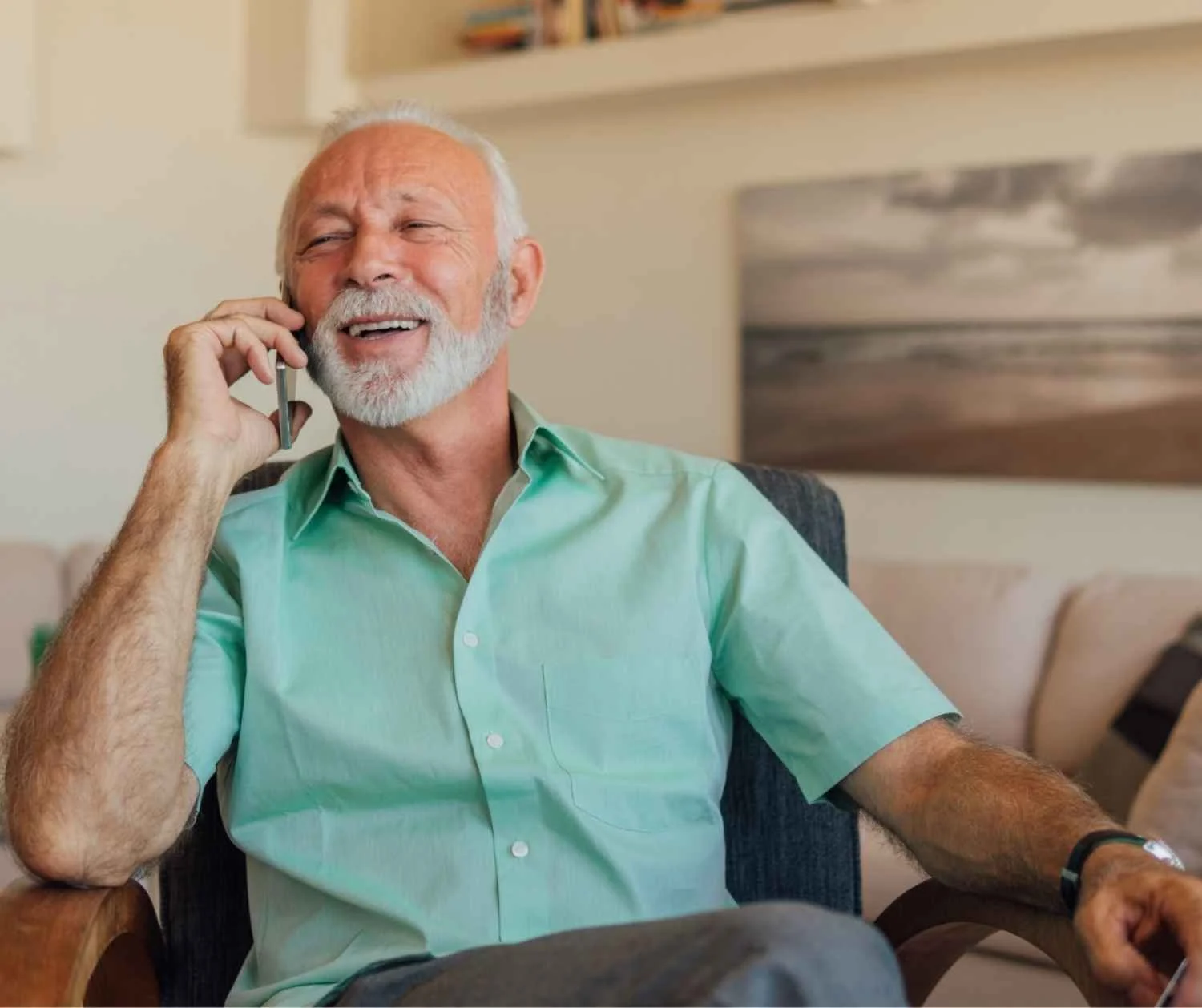 Older man smiling as he talks on the phone
