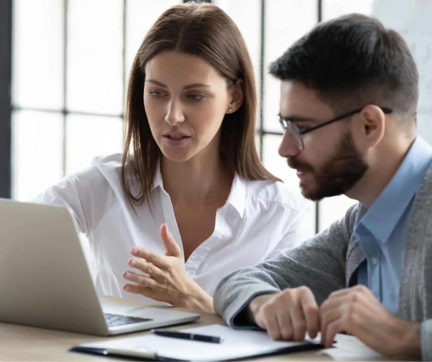 Woman speaking calmly with a coworker in a private one-on-one conversation