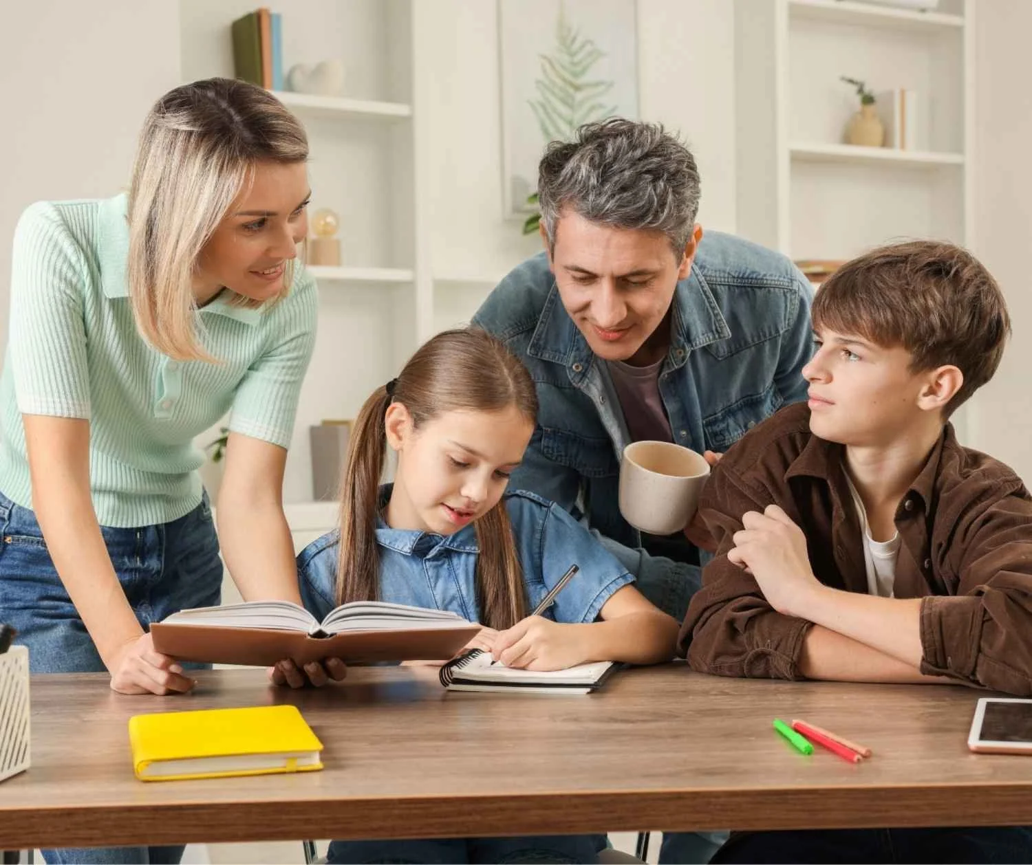 Parents with their young daughter and teenage son at the dining table