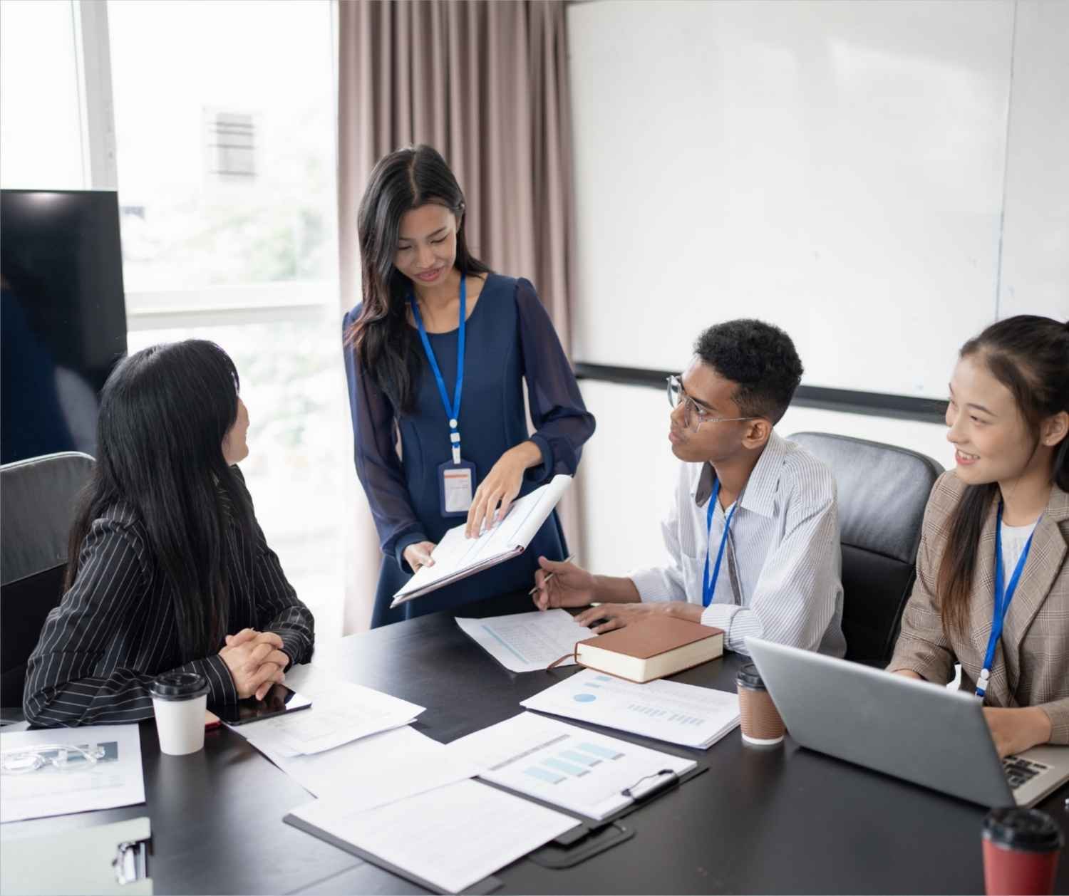 A woman confidently organizing her thoughts while speaking to colleagues