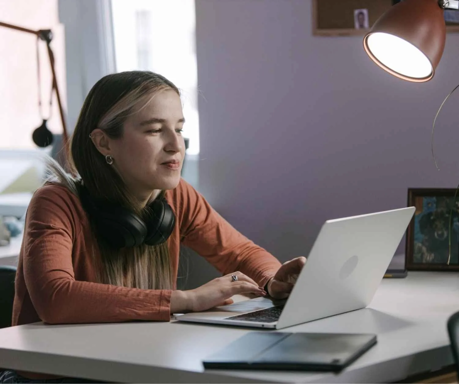 Teenager smiling during a live online coaching session on a laptop