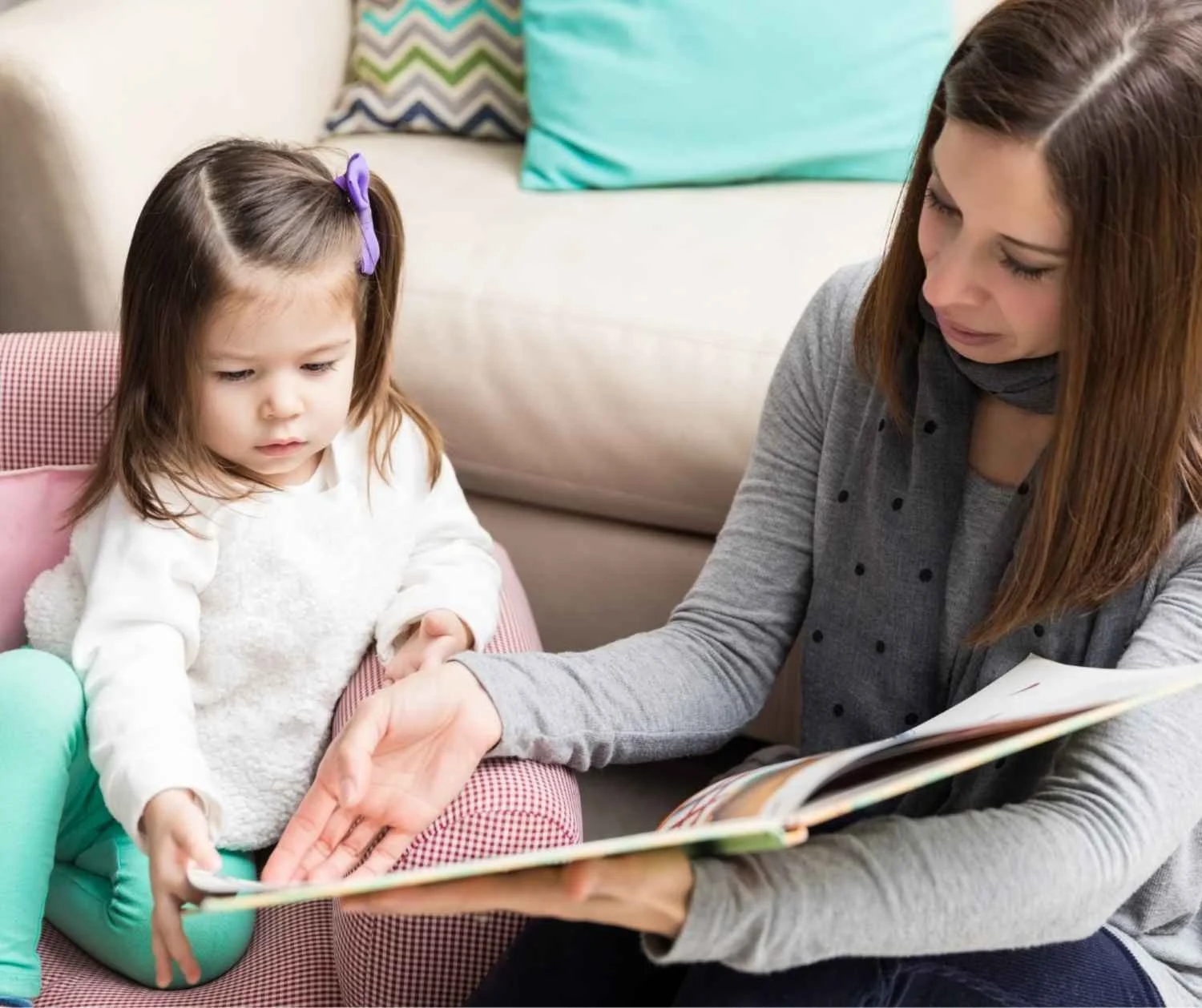 Mother and toddler looking at a picture book together