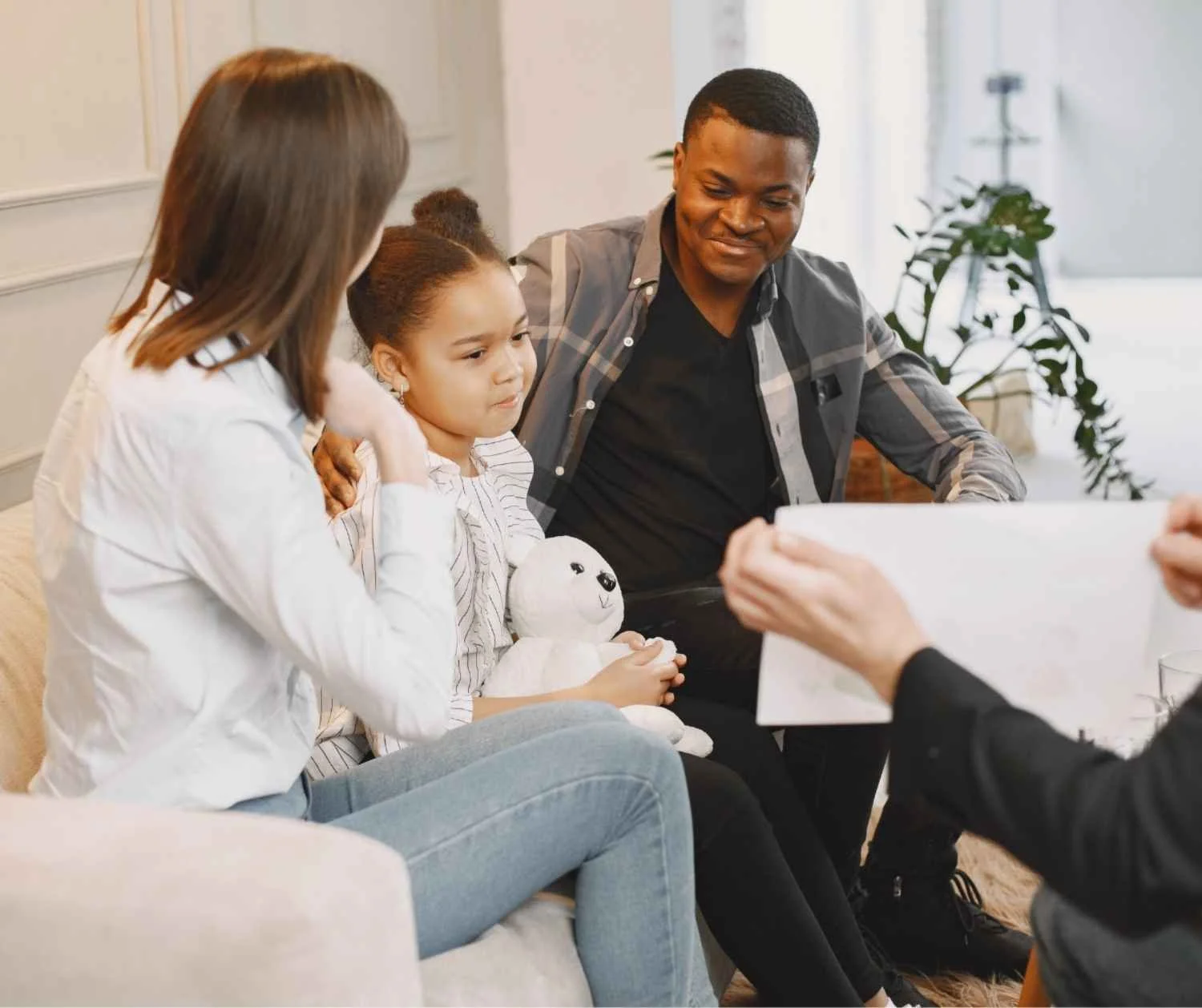 Speech therapist working through picture cards with a young girl.