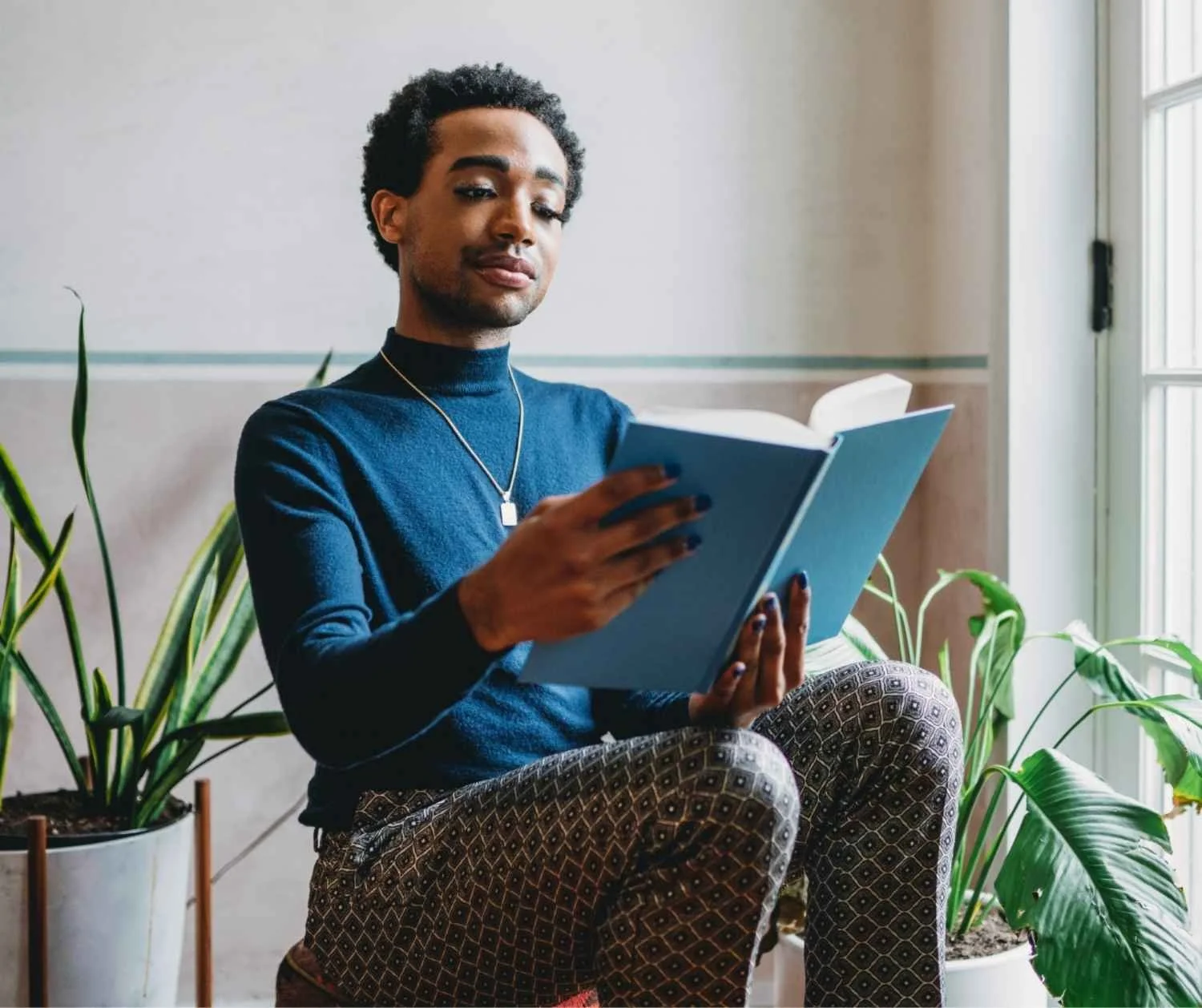 A person reading a book at home