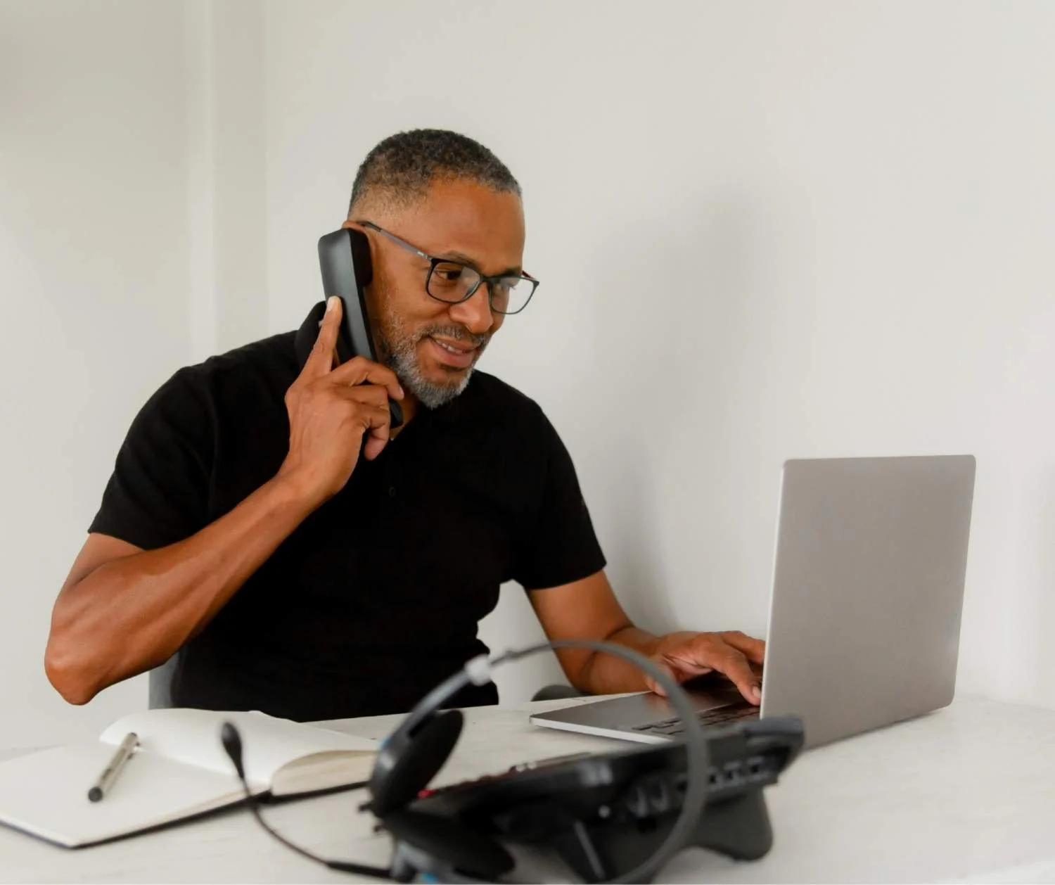 Man smiling during a phone call at home.