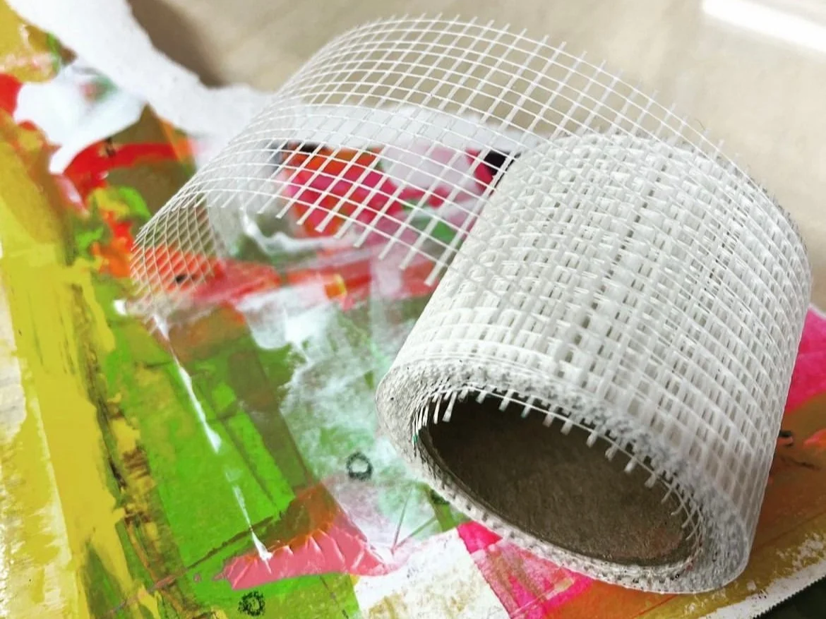 Roll of drywall tape on a colourful abstract background
