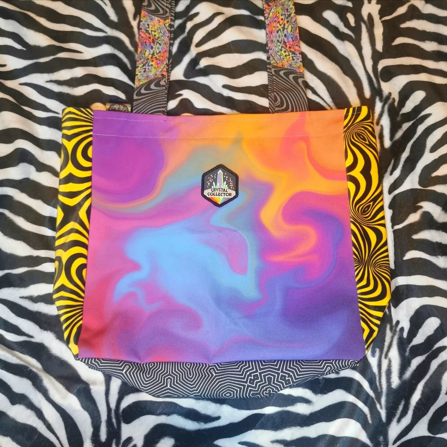 What do you think of our latest bag? 🥰💜

And who needs it because you've got a crystal addiction?! 🙋🤣

Beautiful 'Crystal Collector' embroidered patch 💎Soft velvet bumble bee sides 🐝 and rainbow stitching on the handles 🌈 

Completely unique -