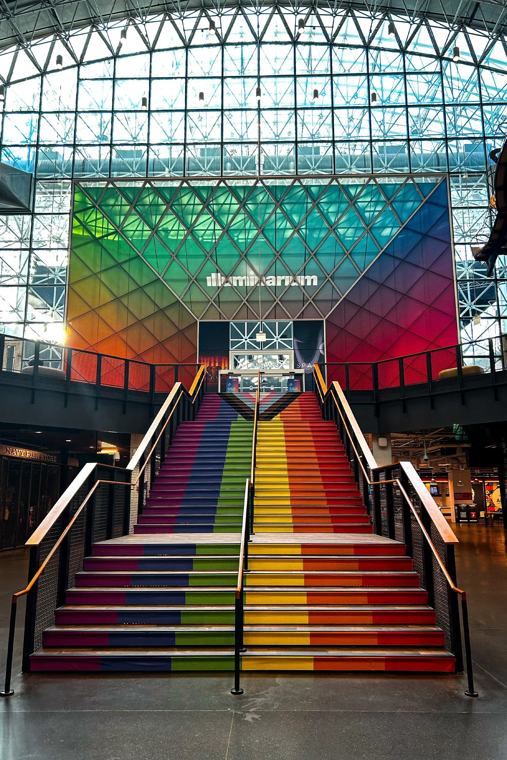Grand Staircase Installation: Central staircase transformed into a large-scale brand moment, using color and pattern to guide movement and create a strong visual focal point.