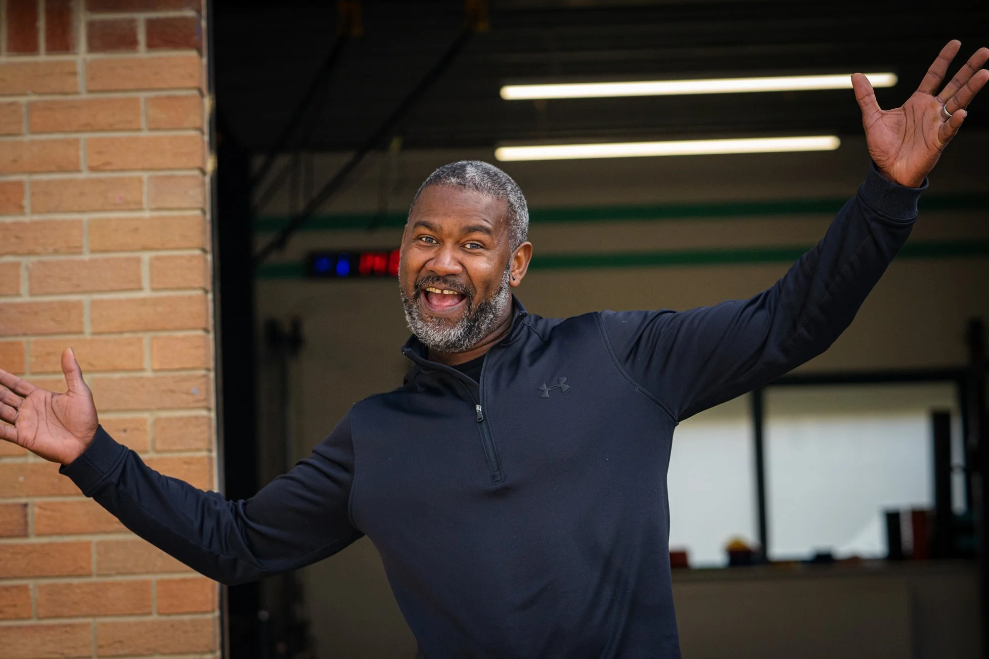Luciano with his arms wide open at the door of Stronghold PT HUB, Cheltenham
