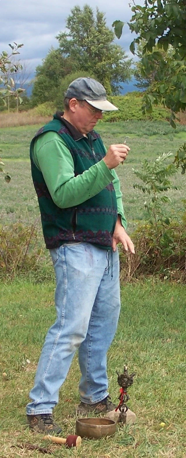 The monk dowsing during a sacred landscaping project.