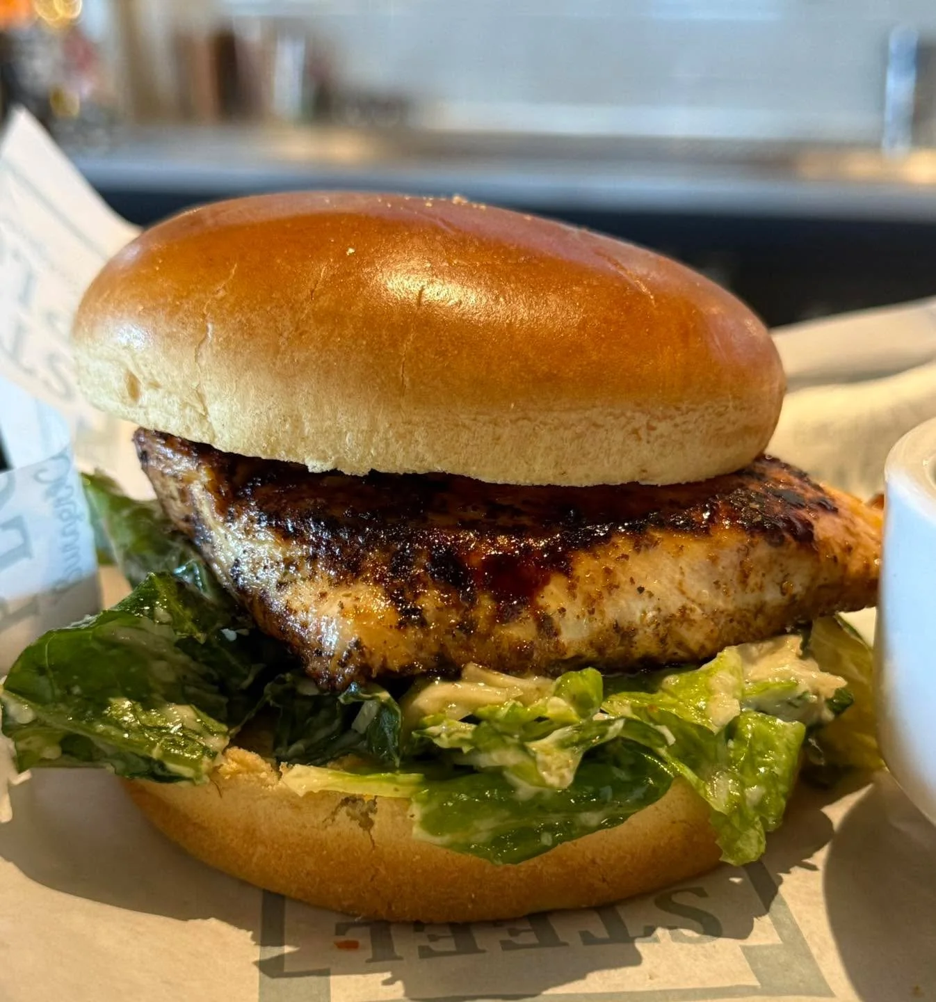🔥🥪 Meet your new lunch obsession. 🥪🔥

Our Chicken Caesar Sandwich is doing the absolute most&mdash;in the best way! Juicy grilled chicken breast, crisp romaine, nutty asiago, and creamy Caesar dressing, all stacked on a buttery brioche bun. Simpl