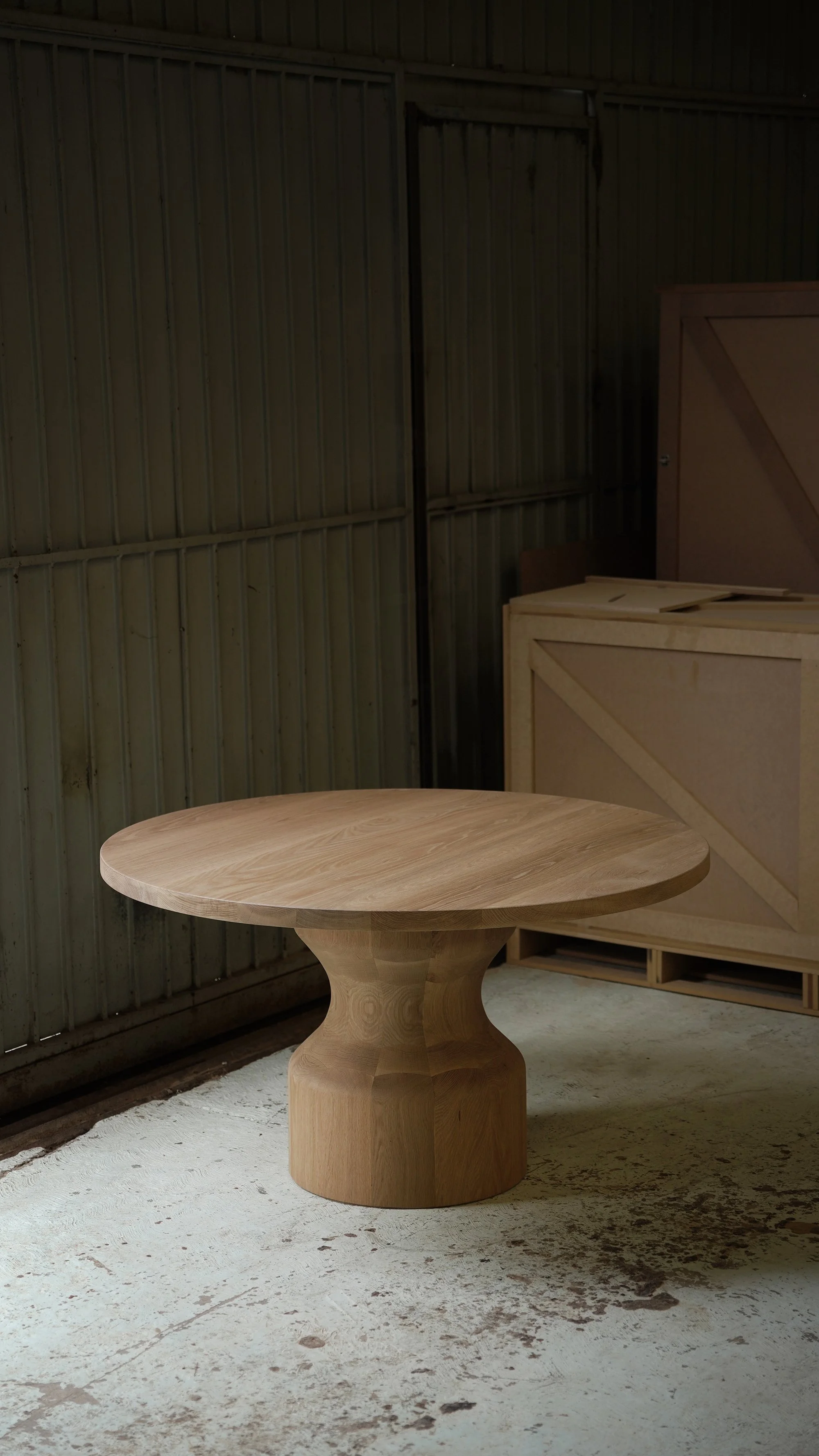 Custom Socle dining table scaled for generous seating and clear circulation around its solid wood base.