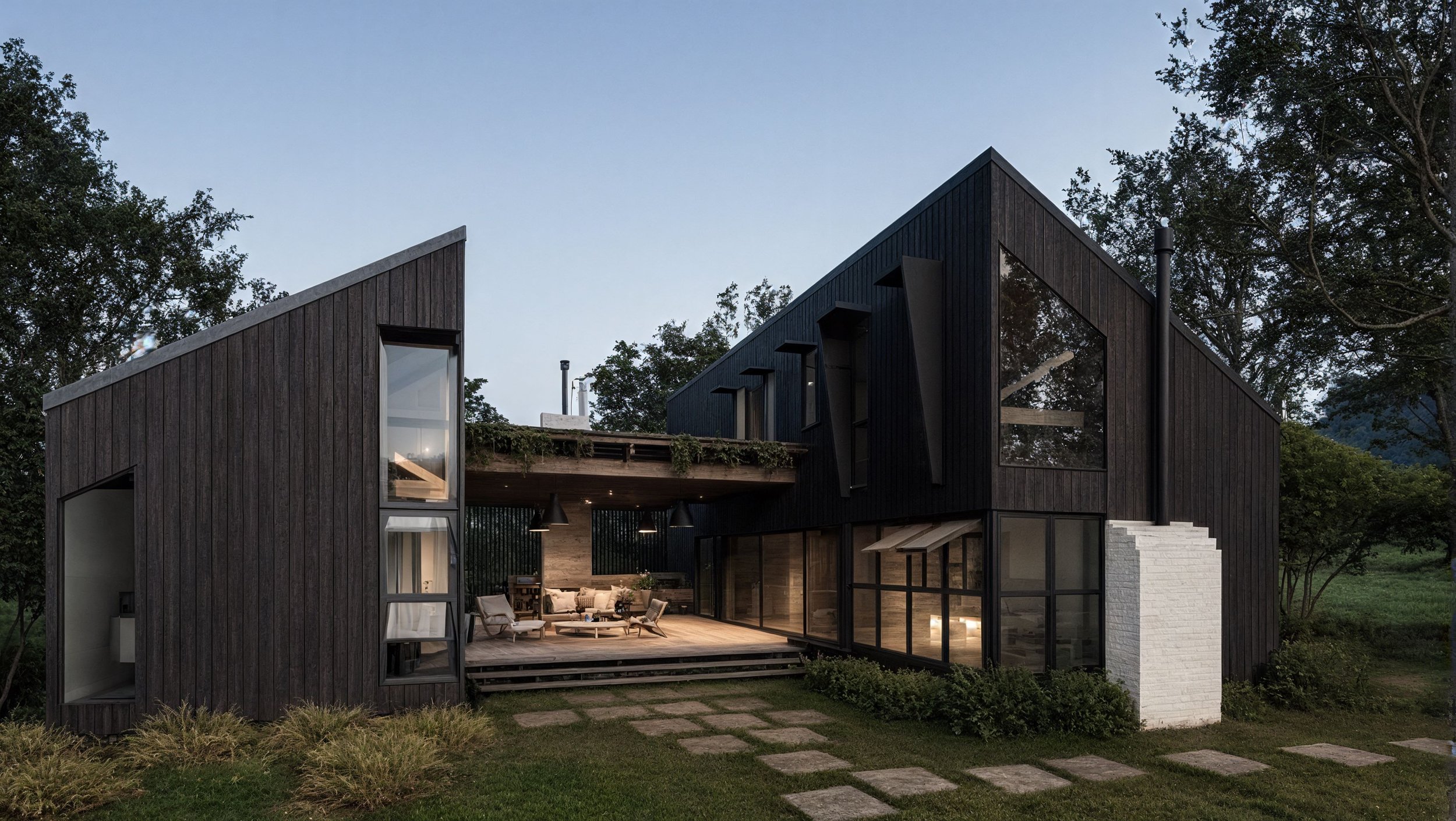 Modern Scandinavian house with large windows and a central connecting outdoor patio area surrounded by green grass and trees.