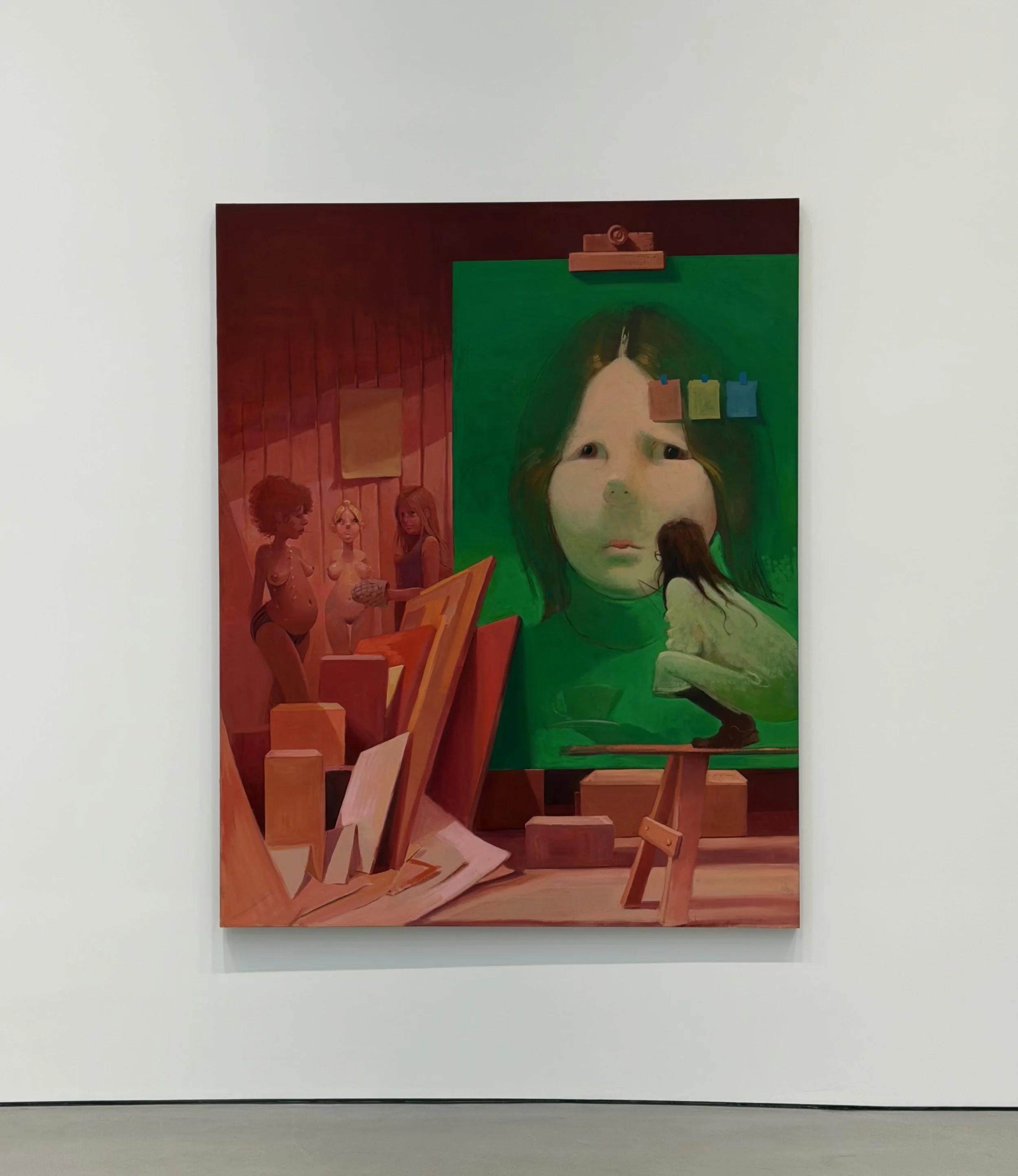 Lisa Yuskavage Self Portrait: Red Yellow Blue showing a pale monumental face inside a studio with female figures.