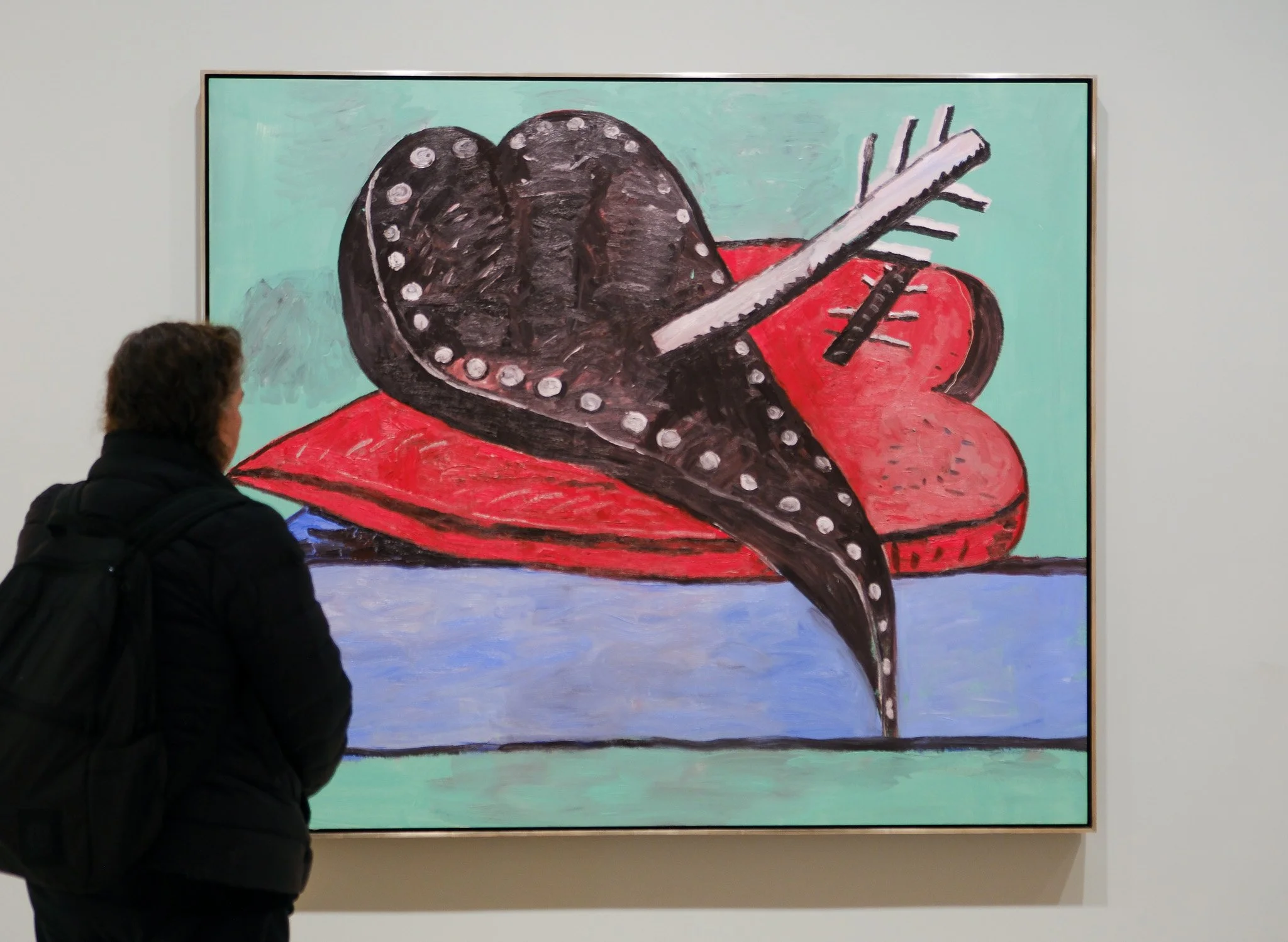 Woman standing before Philip Guston's Two Hearts, 1978, at Hauser & Wirth gallery.