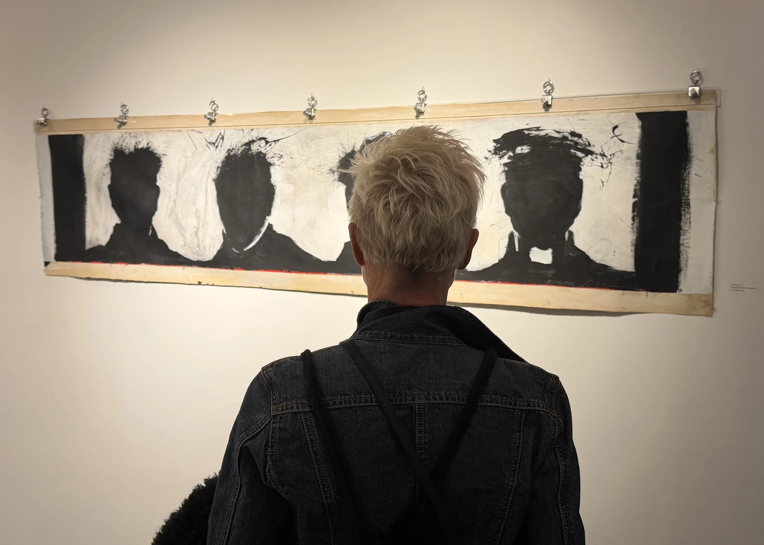 Photographer/artist Eva Mueller considers Richard Hambleton's undated Line Up. Photo by J. Scott Orr