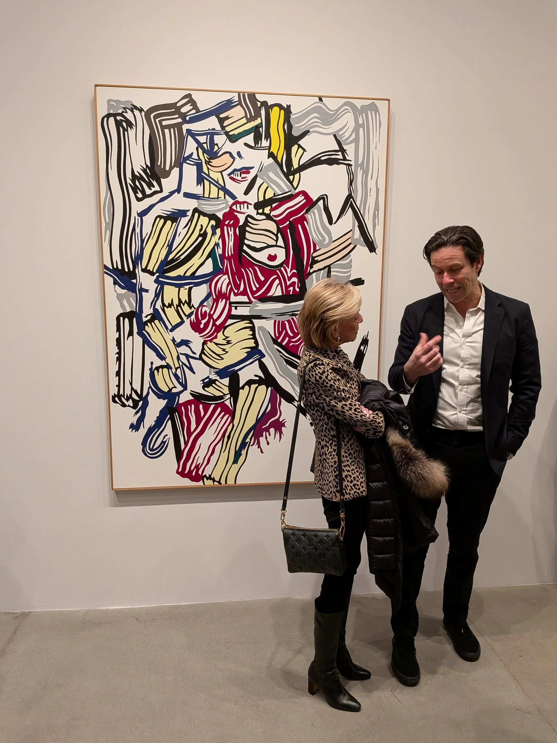 Two gallery visitors stand in front of Roy Lichtenstein's Woman (1981) at Gagosian's Chelsea location.