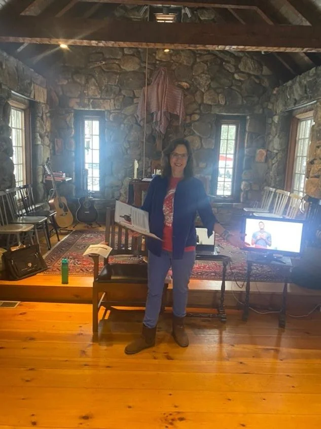 Suze warmly greeting guests as they arrive at the serene Trinity Retreat Center in Cornwall, CT.