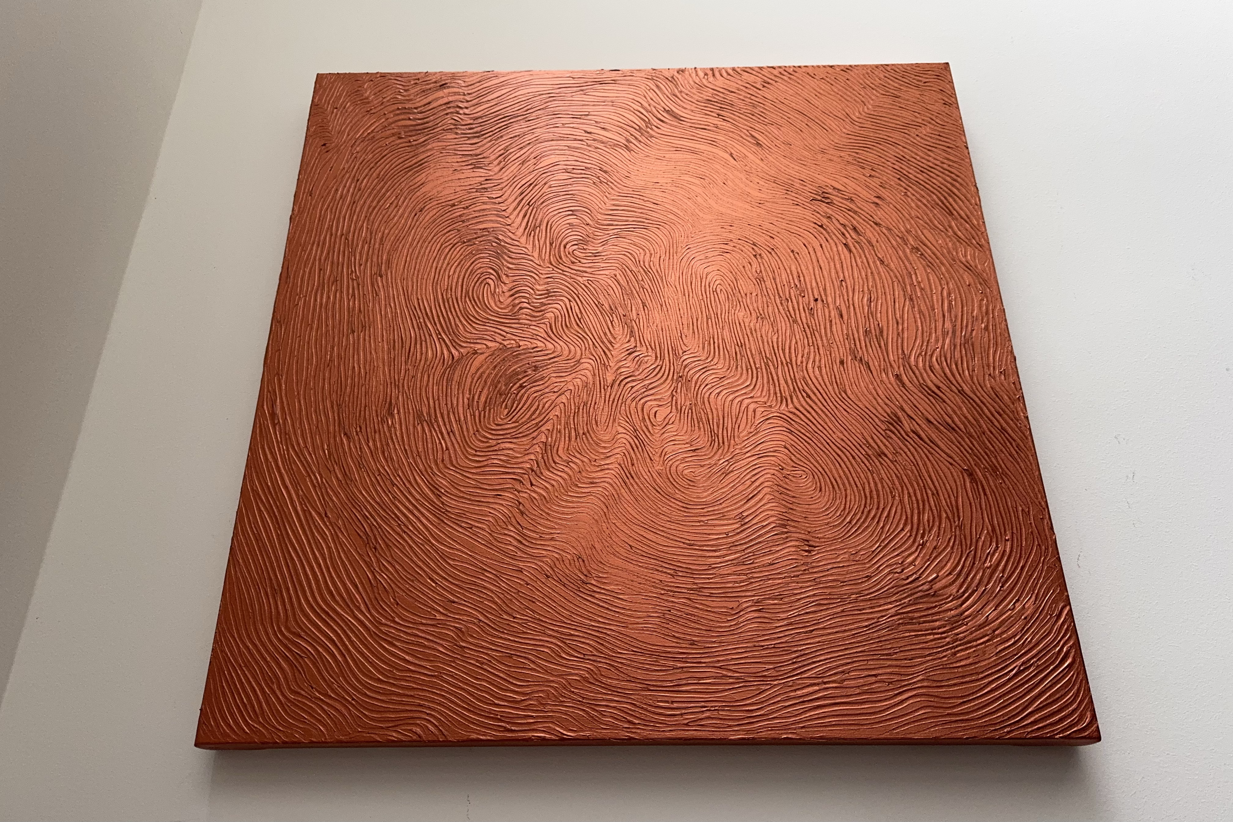 A square painting with swirling black lines on an orange background.
