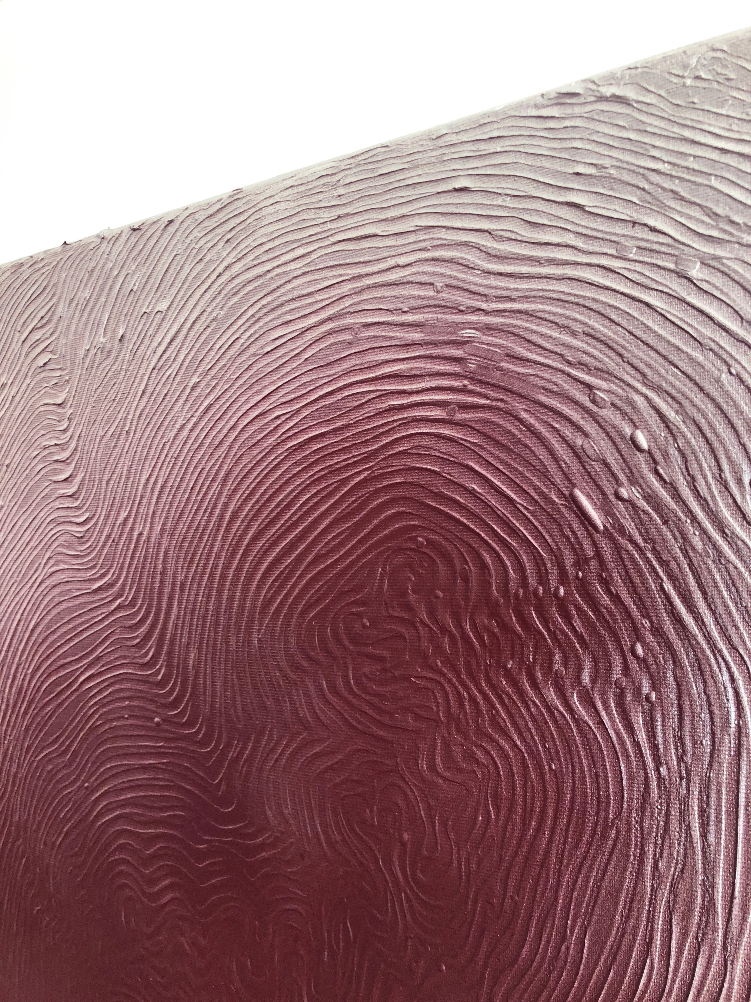 Close-up of a mushroom gill with a textured pattern and droplets of water.
