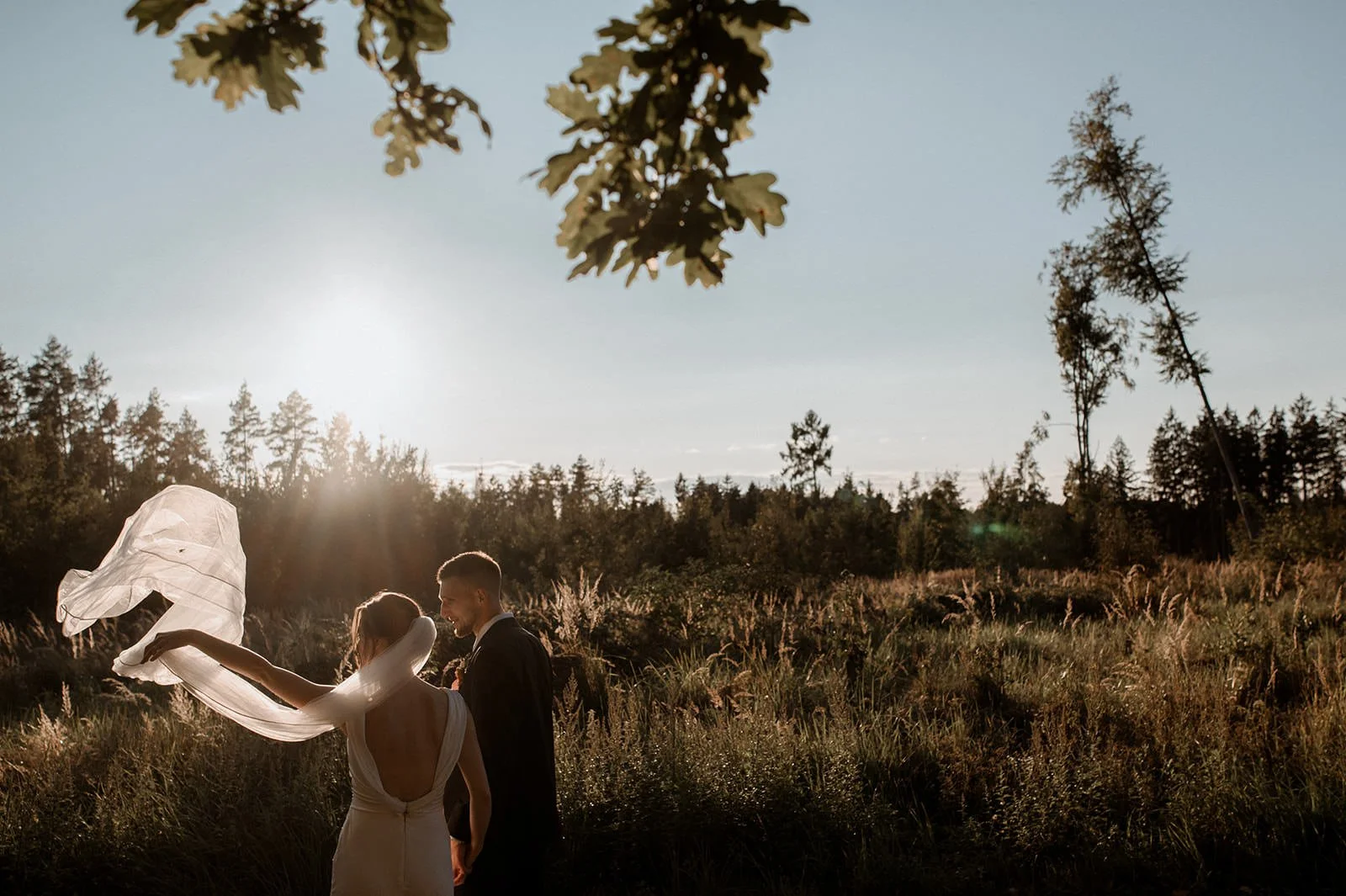 Bride and groom walking through an atmospheric wedding location in Austria, captured in a gentle documentary style