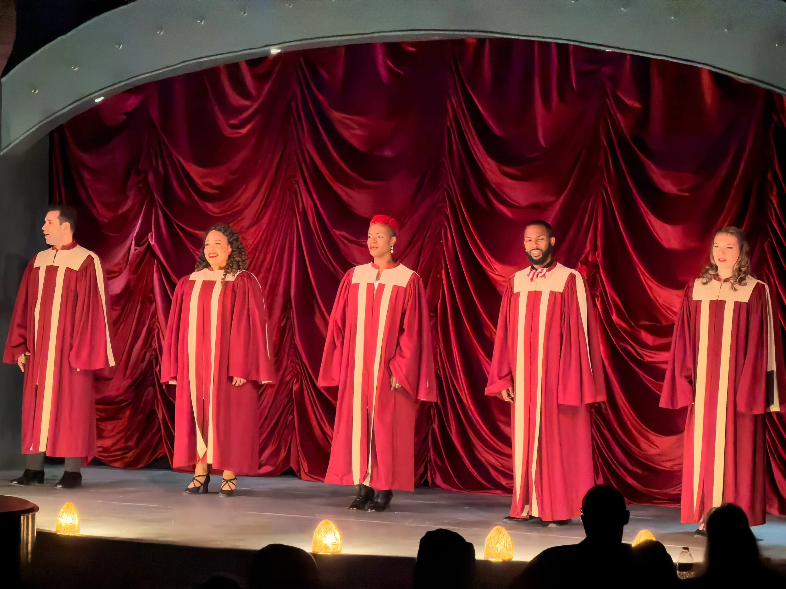The cast singing "Silent Night" to open the show