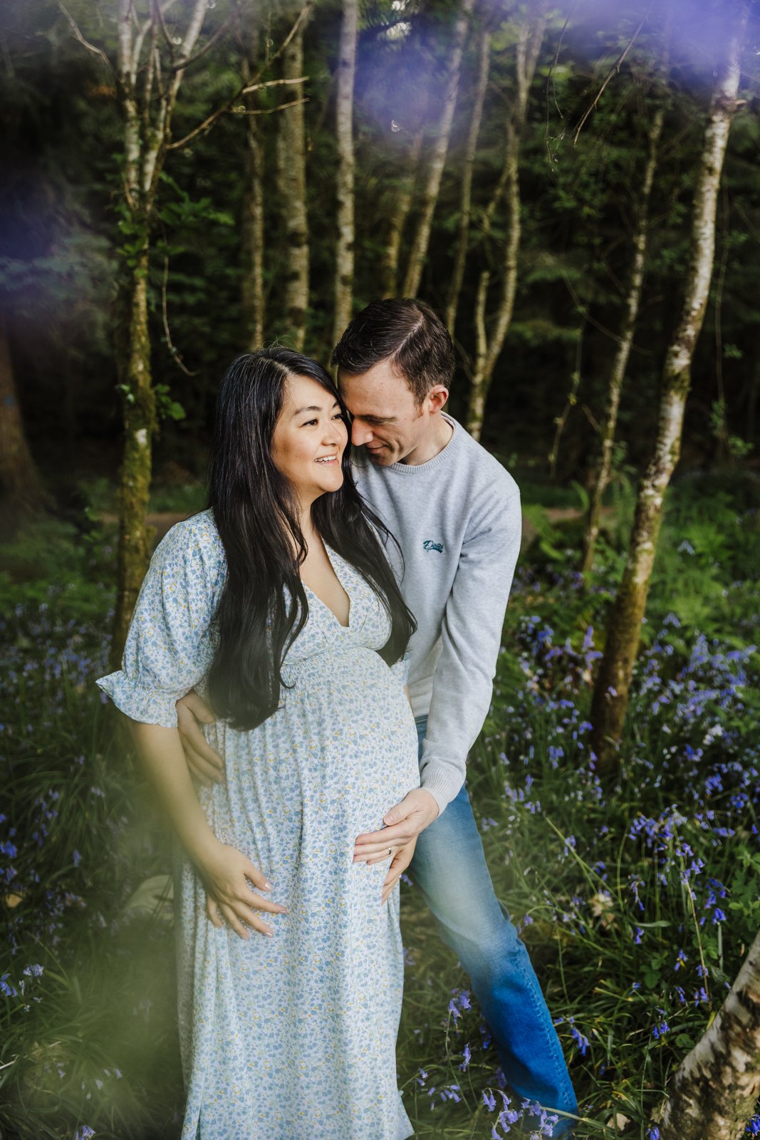 Pregnant Woman + Husband in forrest with bluebells