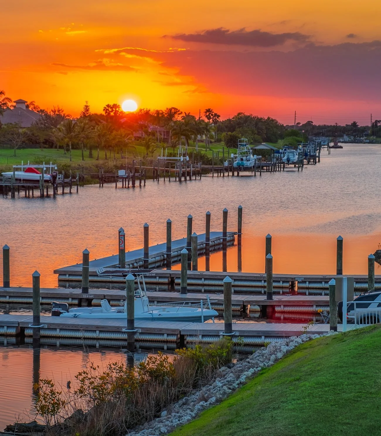 Sunset over a Port St. Lucie, FL canal lined with waterfront homes and private boat docks