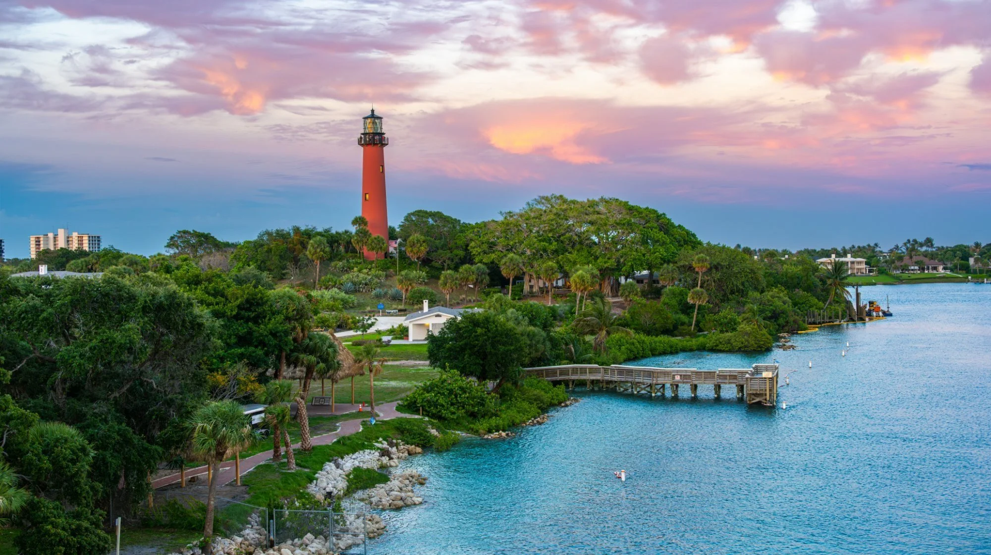 Jupiter Inlet Lighthouse at sunset above the Loxahatchee River and waterfront homes in Jupiter, Florida
