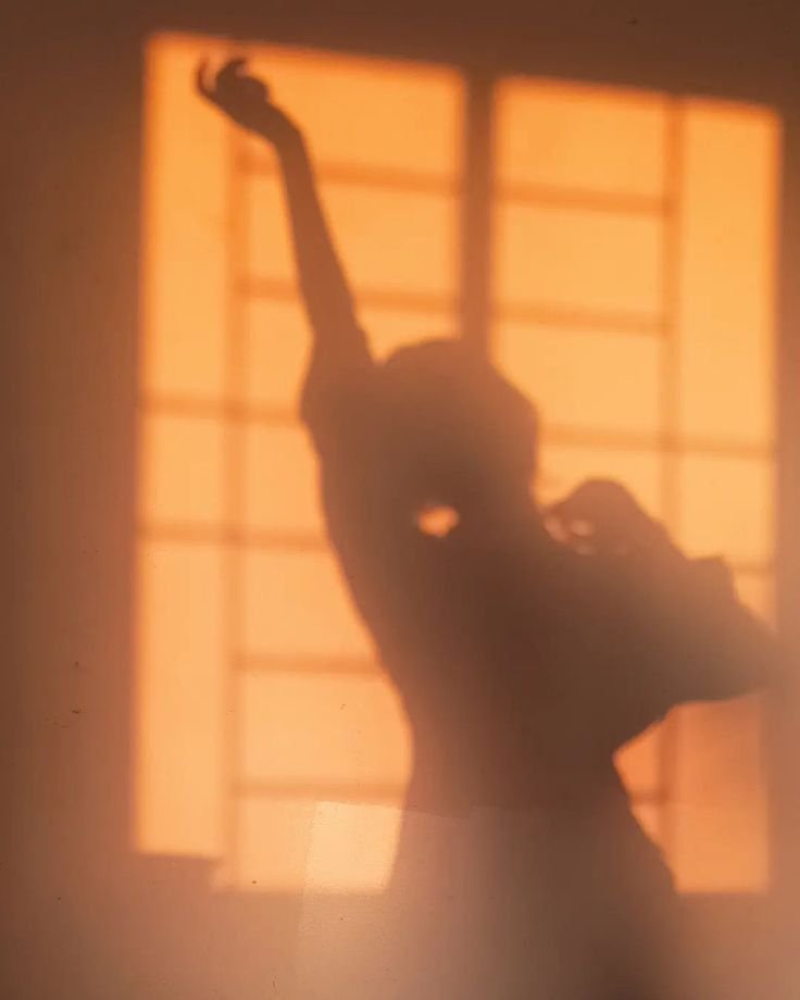 Interior of a church with stained glass window, arched ceilings, and wooden floors.