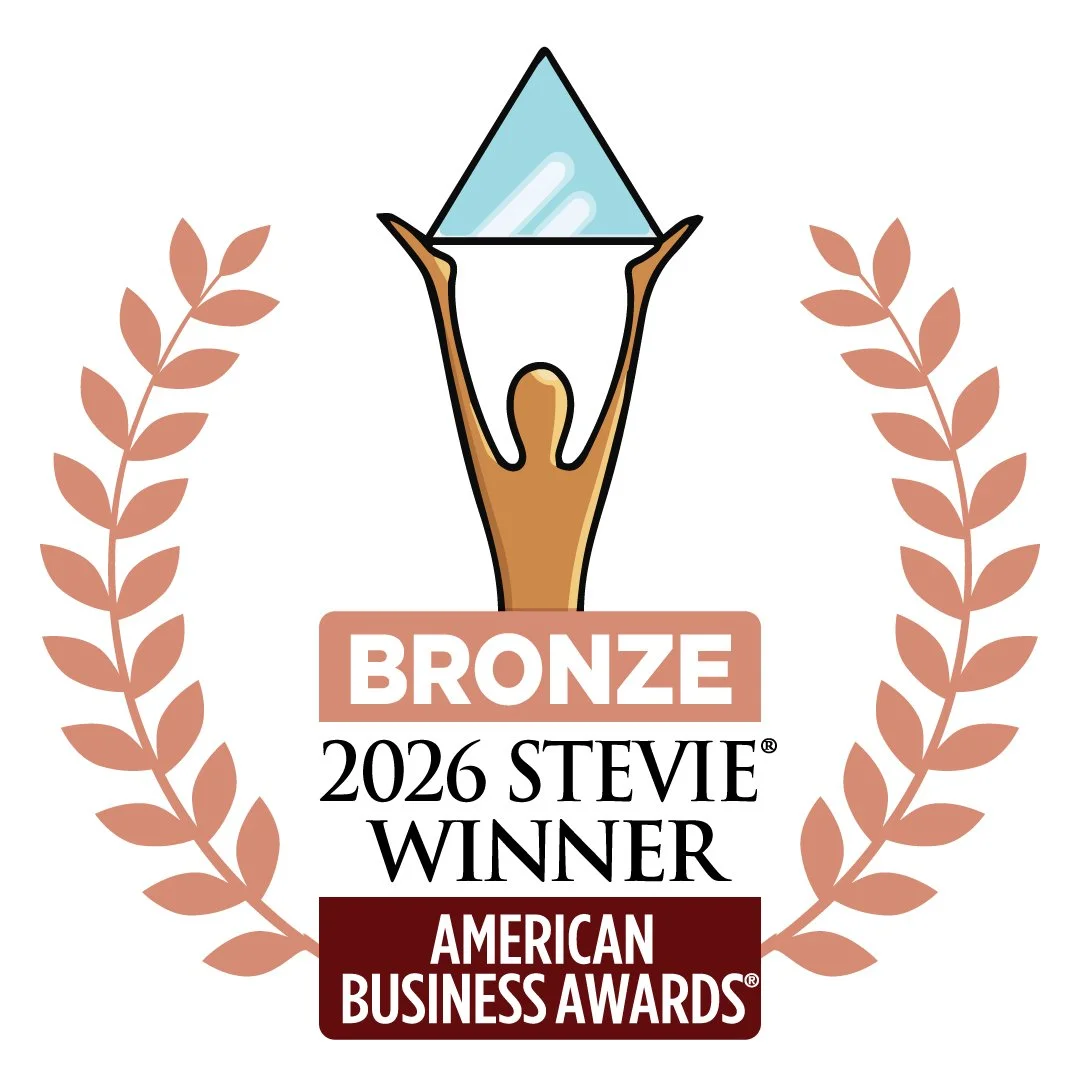 This logo depicts a bronze American Business Award of a bronze person holding a glass triangle. Text below reads "Bronze 2026 Stevie Winner American Business Awards," framed by leaf details.