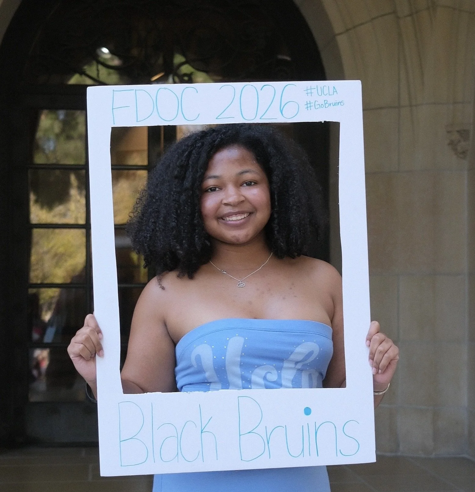 Woman poses with white saying "FDOC 2026 Black Bruins"