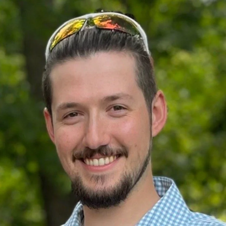 Smiling man with sunglasses on head outdoors