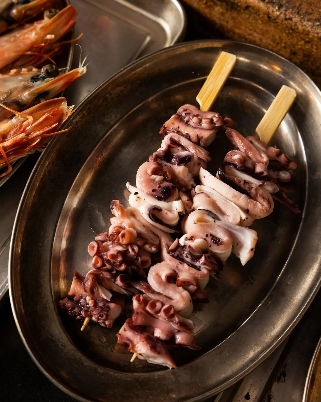 @abrolhosoctopus from the pristine waters of our stunning coastline, kissed by flames. Yakitori style with burnt XO butter, guanciale and yuzu kosho🔥

From the grill at @brownstreetgrill, @cheflawsie doing what he does best. 

Captured by @breadpert