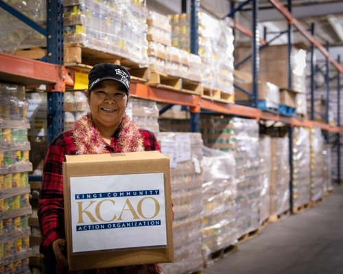 woman holding a box in a food shelter