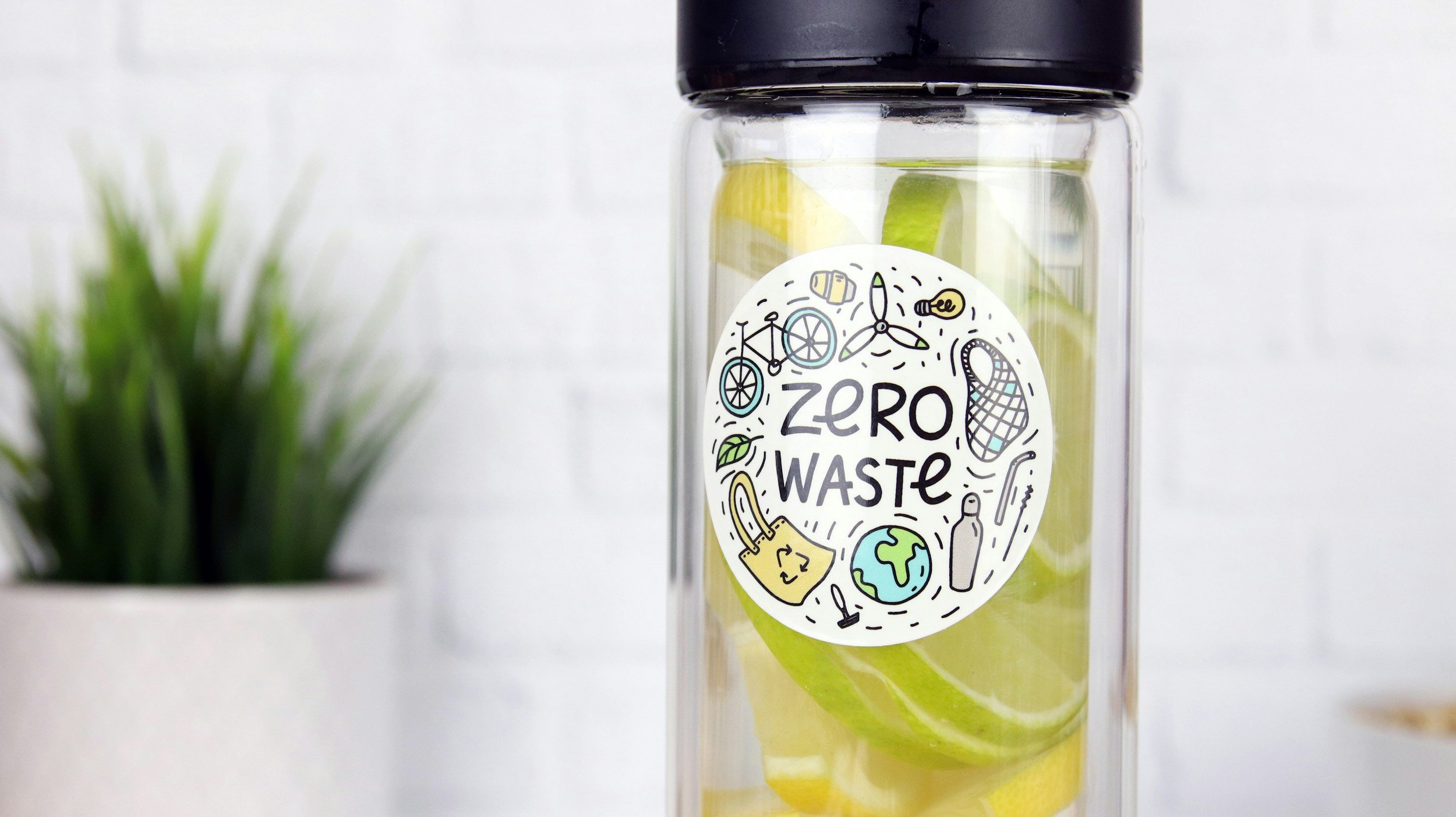 a clear plastic bottle with sticker saying Zero Waste