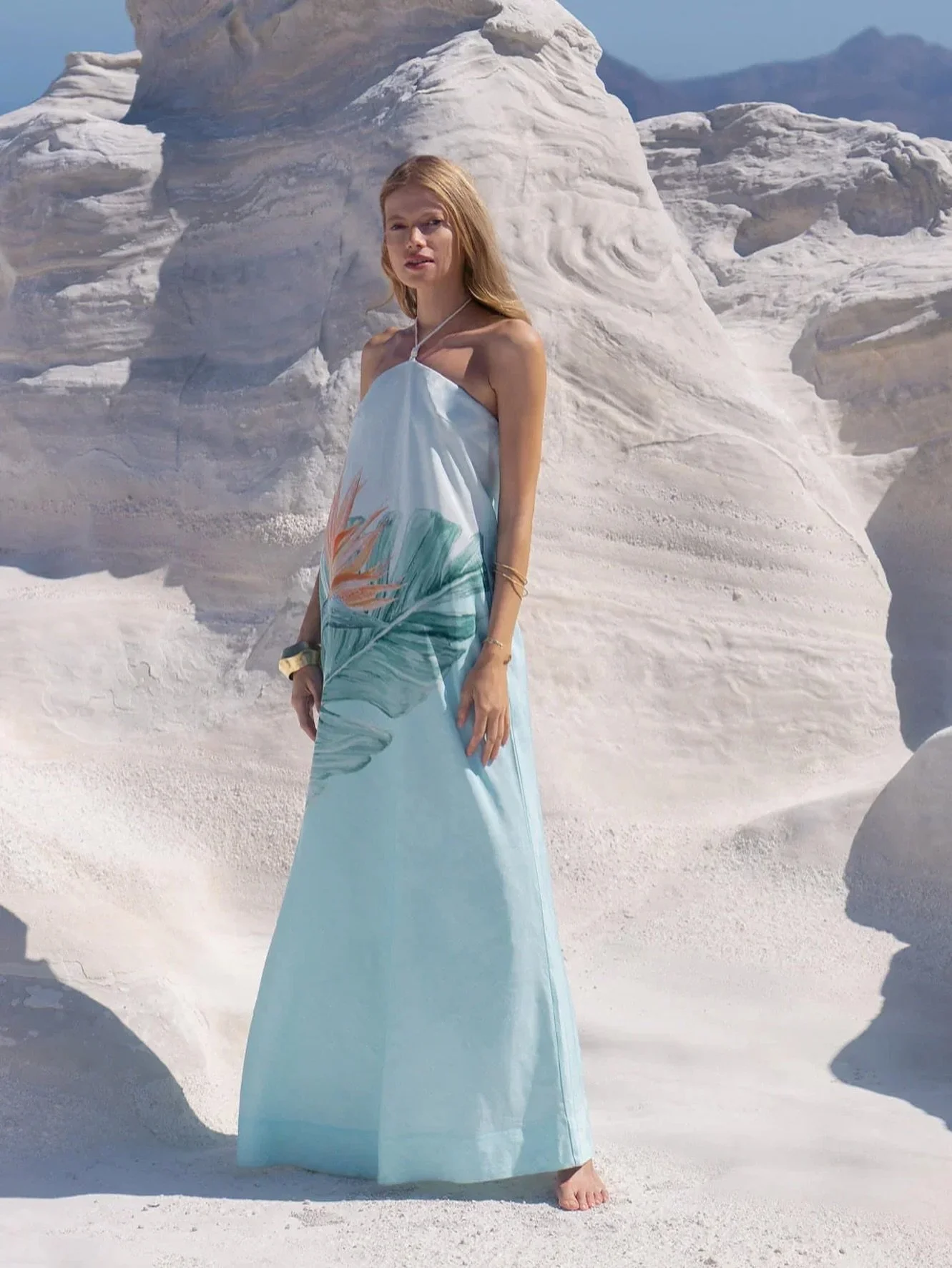 Strapless and softly structured, the Cassia Maxi Dress by KIVARI features a halter tie that can be left undone or fastened with intention. Its form-skimming bodice gives way to a fluid hem, offering movement without excess. The ombr&eacute; base sets