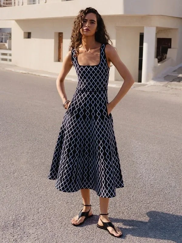Elevate your style with the Tropea Knit Midi Dress from MOS The Label. Its unique blend of retro flair and modern chic is sure to captivate. The black colourway gets a stylish contrast with white accessories, creating a look that's both bold and effo