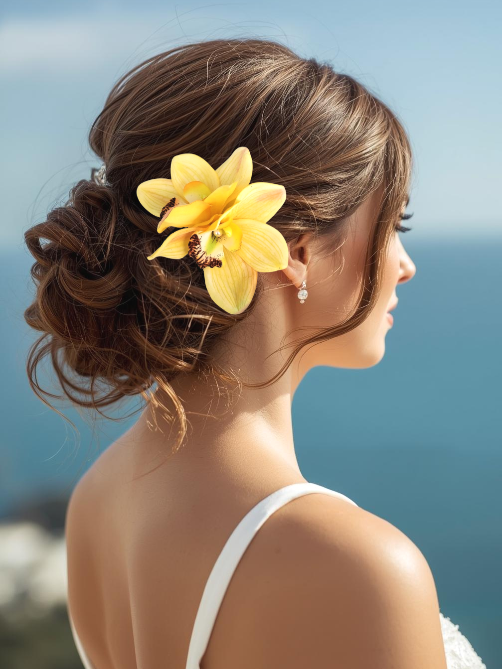 Bride wearing tropical yellow orchid bridal hair flower headpiece