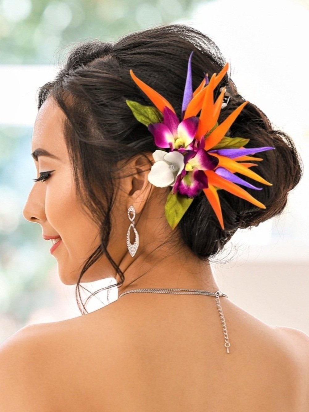 Bride wearing a Bird of Paradise Tropical Wedding Headpiece with silk orchids