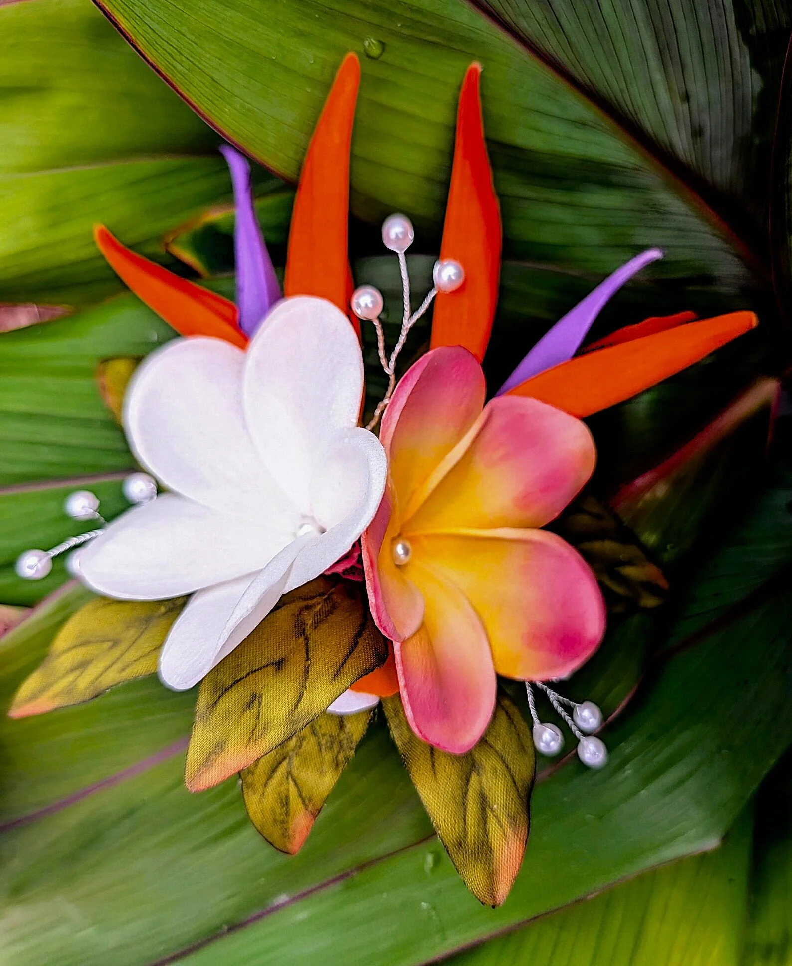 bird of paradise sunset plumeria pearls worn by blonde bride