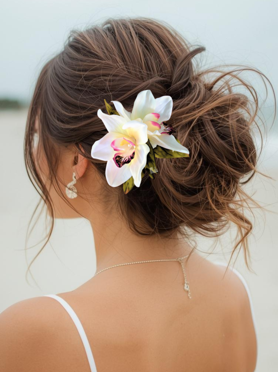 Beach bride wearing double white silk orchid hair clip